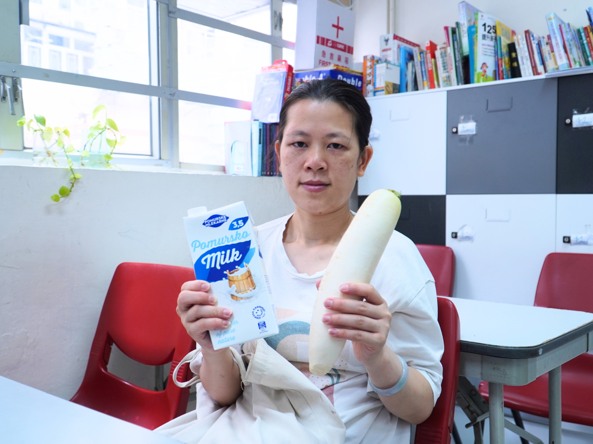 a lady holding some food donation. 