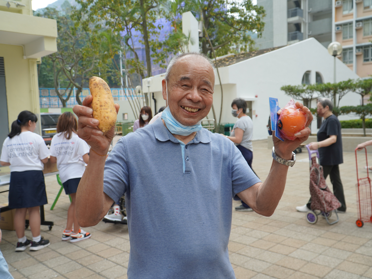 a man holding sweet potatoe